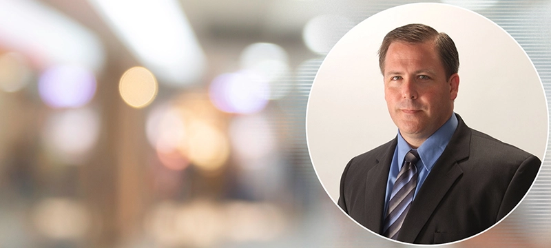 An image of Dr. Jonathan Cole over a background of a general medical setting, representing how Dr. Cole uses PAR assessments in his practice for medical patients